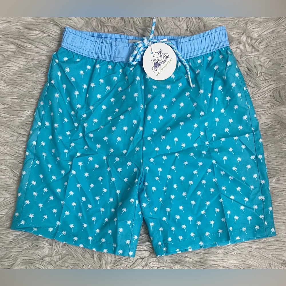 New with tags boys size 12 swim trucks in a bright color with palm tree design.